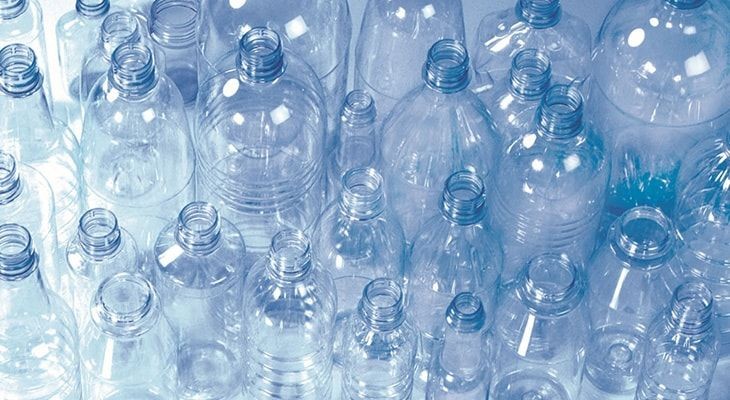 Collection of empty clear plastic bottles in various sizes and shapes, viewed from above.